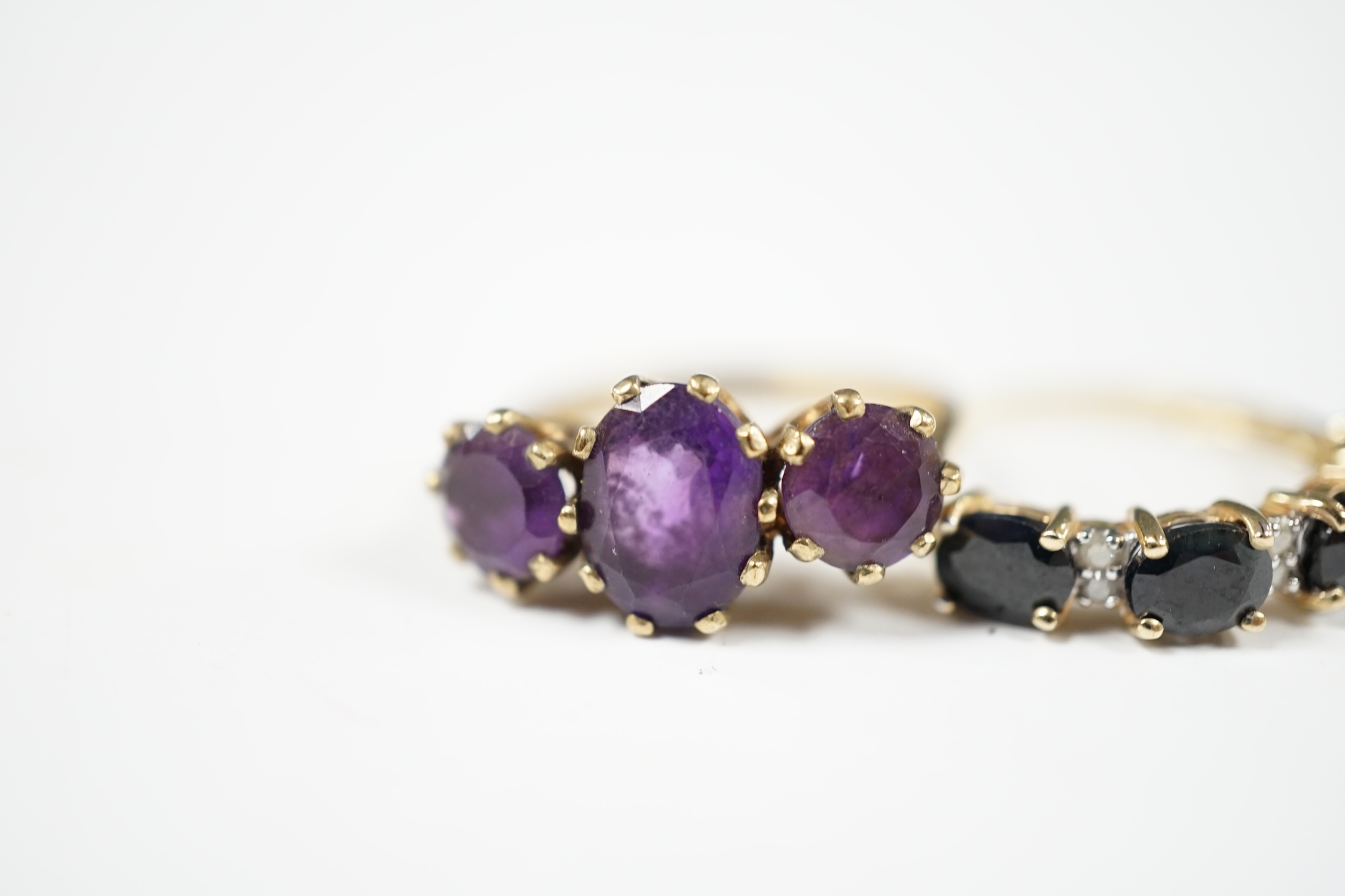 Two modern 9ct gold and gem set rings including three stone amethyst, size O and sapphire and diamond chip half hoop, gross weight 4.9 grams. Condition - fair